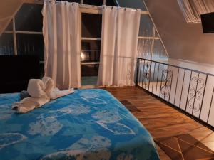 a bedroom with a bed with a stuffed animal on it at Termales el Ocho Villa Santa Helena in Zetaquira +18 photos