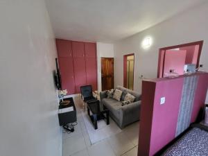 a living room with a couch and a table at chic studio - 10 minutes du plateau in Abidjan