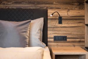 a bedroom with a bed and a table with a lamp at Chalet Bel Plan in Ortisei +85 photos