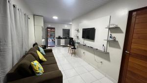 a living room with a couch and a tv at Casa Paraíso de Alter in Santarém