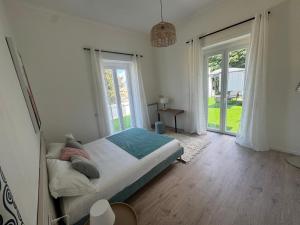 a bedroom with a bed and a large window at Bella Ischia in Ischia