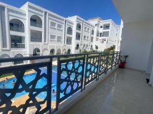 a view of the pool from the balcony of a building at Appartement de luxe à Tanger Maroc in Tangier