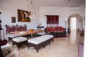 a living room with a wooden table and chairs at Dar Ullaya in Hammamet