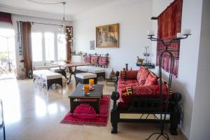 a living room with a couch and a table at Dar Ullaya in Hammamet +21 photos