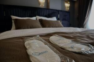 a bed with two shoes on top of it at Classio Hotel Kadıköy in Istanbul