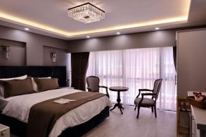a bedroom with a bed and a table and chairs at Classio Hotel Kadıköy in Istanbul