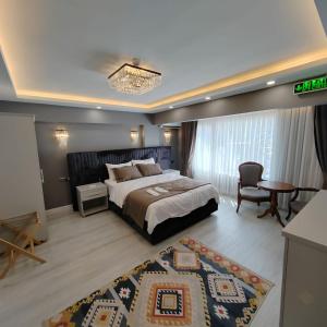 a bedroom with a bed and a table and a chair at Classio Hotel Kadıköy in Istanbul