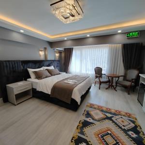 a bedroom with a bed and a table and chairs at Classio Hotel Kadıköy in Istanbul