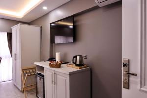 a kitchen with a counter with a coffee maker on it at Classio Hotel Kadıköy in Istanbul