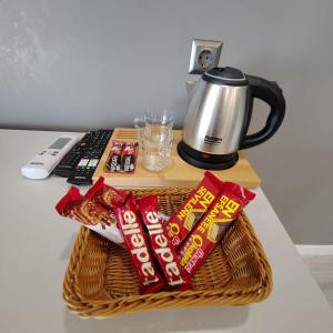 a basket of candy on a table with a coffee maker at Classio Hotel Kadıköy in Istanbul
