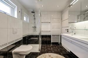 a white bathroom with a toilet and a sink at Chalet Roma 200 in Sint Annaland +38 photos