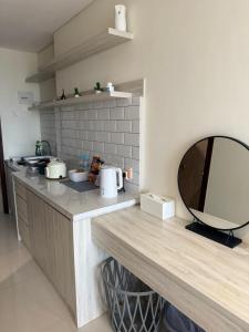 a kitchen with a counter top with a mirror at Pollux Habibie Deluxe Sea View By Superstay in Batam Center