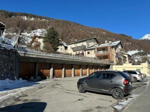 a car parked in a parking lot next to a mountain at Chasa pin in Müstair