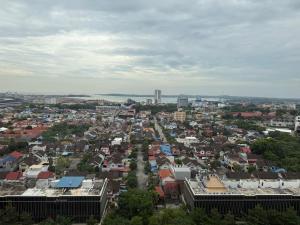 an aerial view of a city with buildings at Pollux Habibie Deluxe Sea View By Superstay in Batam Center