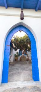 an archway with blue paint on the side of a building at La Casa de las Higueras Dar Karmus Tetouan in Tetouan