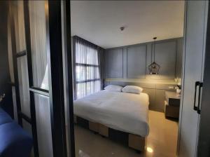 a bedroom with a bed and a window at The Palmirah Surin by SP in Surin Beach +6 photos