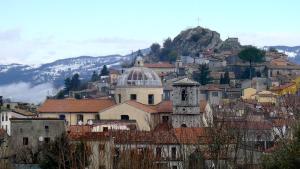 a town on a mountain with a clock tower at La Lucanella in centro a Rotonda in Rotonda