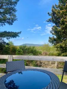 a table and chairs with a blue table and a view at Bynack Lodge in Boat of Garten +44 photos