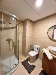 a bathroom with a shower and a toilet and a sink at Suite Horizon in Mohammedia