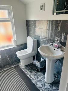 a bathroom with a toilet and a sink at Large 'n' bright House in Middlesbrough