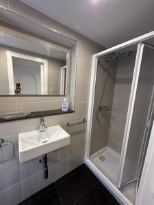 a bathroom with a shower and a sink and a mirror at L'Esglesia 3 in Arenys de Mar