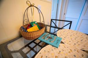 a basket of groceries sitting on a table with a book at Cozy Bee Hive- Cheerful Stay Near Town in Mount Vernon