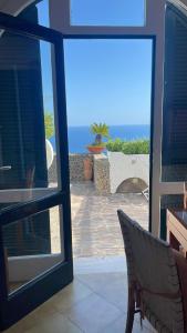 a view of the ocean through a sliding glass door at Villa La Birbirella in Conca dei Marini