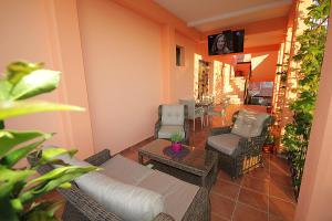 a living room with a couch and chairs and a table at Apartments Radosavovic in Bar
