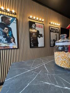 a table in a room with posters on the wall at Appartement centre ville Laval avec cinéma in Laval
