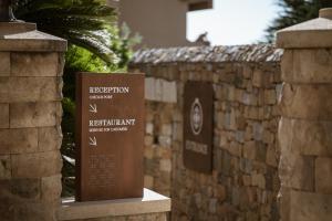a sign for the reptition conservation center in front of a stone wall at Villa Dei Melograni Boutique Hotel in Cefalù