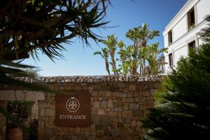 a sign for the entrance to an apartment building at Villa Dei Melograni Boutique Hotel in Cefalù