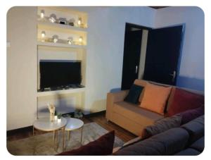 a living room with a couch and a table at villa EMMANUEL 1 in Antananarivo