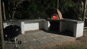 a fire pit with a pizza oven in a backyard at Golden Acre Farm in Mansfield