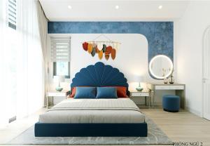 a bedroom with a blue bed with a blue headboard at Bali Villa- Đối diện Tropicana Park - Novaworld Hồ Tràm in Ho Tram