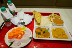 a tray of food with rice and vegetables on a table at Urvi Banquets & Guest House in kolkata