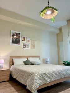 a bedroom with a bed and a chandelier at Favola Guesthouse Affittacamere in Nettuno