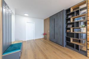 a living room with a large bookshelf at Luxury Apartments Calithea-Balchik, Free Parking in Balchik