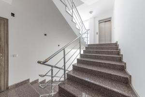 a staircase in a white building with a metal railing at Luxury Apartments Calithea-Balchik, Free Parking in Balchik