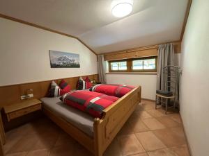 a bedroom with a bed in a small room at Landhaus Brigitte in Obermaiselstein
