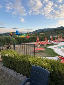 a view of a pool with chairs and a playground at Sogni d'insonnia in San Sosti