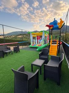a balcony with a playground with tables and chairs at Sogni d'insonnia in San Sosti