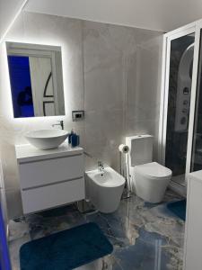 a white bathroom with a sink and a toilet at Naomi Luxury Home 3 in Catania