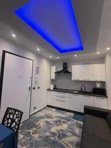 a kitchen with a blue light on the ceiling at Naomi Luxury Home 3 in Catania