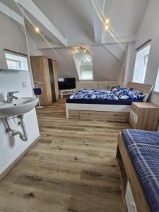 a bedroom with a bed and a sink in a room at Apartment in Gaspoltshofen