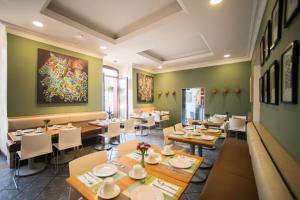a restaurant with tables and chairs and a painting on the wall at Hotel Abu in Oaxaca City