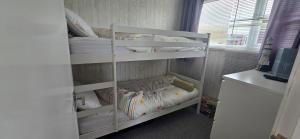 a bedroom with two bunk beds in a room at Foxys Seaside Retreat in Withernsea