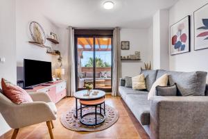 a living room with a couch and a tv at Oasis in Los Collados - 2BR - Pool & Garden in Águilas