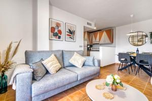 a living room with a couch and a table at Oasis in Los Collados - 2BR - Pool & Garden in Águilas