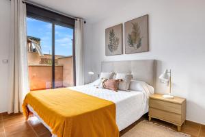 a bedroom with a large bed with a yellow blanket at Oasis in Los Collados - 2BR - Pool & Garden in Águilas +34 photos