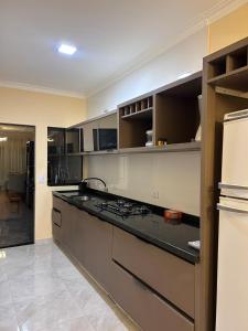 a kitchen with a counter top and a refrigerator at Furnished house in Fazenda Rio Grande